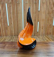 front view of orange and black ceramic flame sculpture