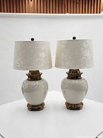 Pair of Chapman ceramic and brass table lamps with shades displayed side by side