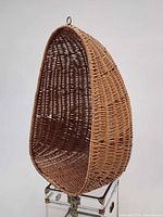 Front three-quarter view showing full egg shape and wicker condition