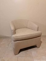 Front angled view of upholstered club armchair