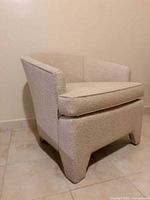 Front-side view of upholstered club armchair