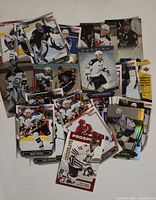 scattered sample of hockey trading cards showing various players and brands