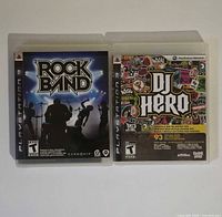 Front view of both PS3 games Rock Band and DJ Hero in cases