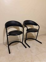 Front view of both black cantilever chairs