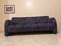 Full front view of sofa showing entire design and upholstery
