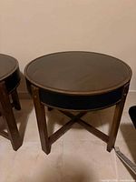 Full view of round side table showing glass top and wooden frame
