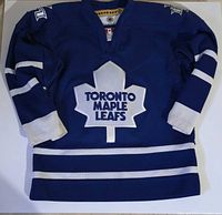Front view of blue KOHO Toronto Maple Leafs youth jersey showing crest and stripes