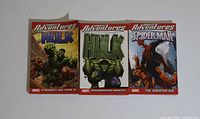 Front covers of three Marvel Adventures paperback books