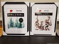 Front view of both black wood photo frames with mats and corner protectors