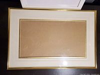 Gold-tone rectangular frame with mat
