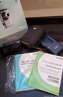 Whole lot: camera, charger, case, box, manuals, CDs