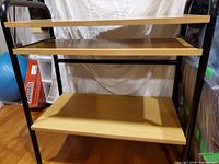 Full view showing three shelves and metal frame