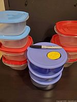Front view of stacked rectangular and round food storage containers