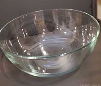 angled view of clear heavy glass bowl showing overall shape and thickness