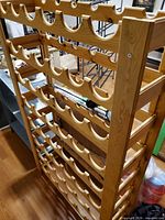 Full front angle of wooden wine rack showing all 8 shelves
