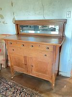 Front view of oak buffet sideboard with mirror back