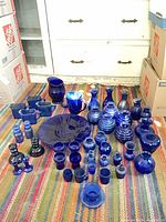 group shot of all cobalt blue glass pieces on rug