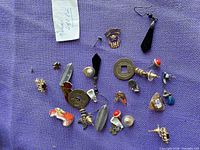 Overall view of assorted earrings on purple fabric
