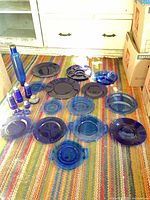 Lot overview showing plates, bowl, bottle, shakers