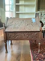 Front view of carved chest on legs