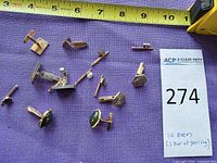 All 14 pieces displayed with tape for scale