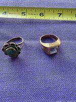 Both rings beside measuring tape showing size relation