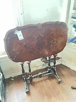 Full view of tilt-top table in folded vertical position