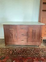 Front view of buffet showing doors, drawers, wood tone, hardware