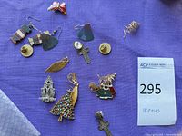 All jewellery pieces laid out on purple cloth with lot tag visible