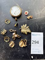 All 17 pieces laid out on black surface with lot tag