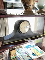 Front view of mantel clock on shelf