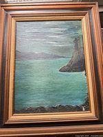 Full view of framed seascape painting