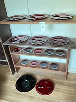 Shelved ruby red divided plates – top shelf large plates, middle shelf large plates, bottom shelf smaller plates