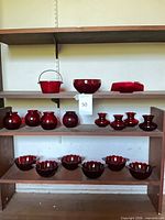 All ruby red glass items arranged on shelves