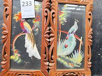 Both feather pictures side by side showing carved wood frames and bird designs