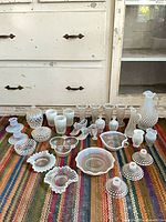 Entire lot laid out on rug showing quantity and variety