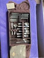 Flatware set in brown felt case showing full assortment