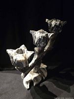 Front angle of black and white alabaster three-arm candle holder