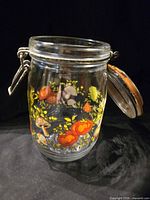 Front view glass canister showing Spice of Life motif and clamp lid