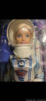 Close-up of Barbie head and helmet inside package