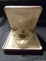 Ashtray inside open Maporica case showing branding and satin lining