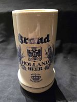 Front view showing Brand Holland Beer graphics and overall condition