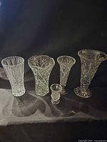 Front view of five crystal vases side by side