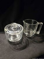creamer and lidded sugar bowl side by side