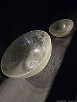 Top view of both clear glass bowls showing size difference and leaf motif