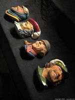 All four chalkware character heads on black background
