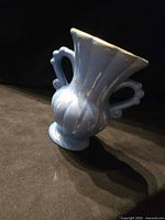 Front view of blue twin-handled ceramic vase