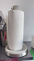 Paper towel holder with roll in place