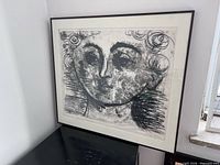 Full view of framed lithograph on table