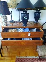 Two open dresser drawers filled with folded men’s sweaters